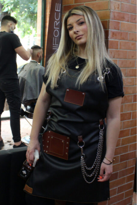 Black Leather Apron with metal chains, towel-ring, and adjustable cross-back straps. Ideal for tattoo artists, craft makers, butchers, grilling, hairstylists, metalworkers, and more.