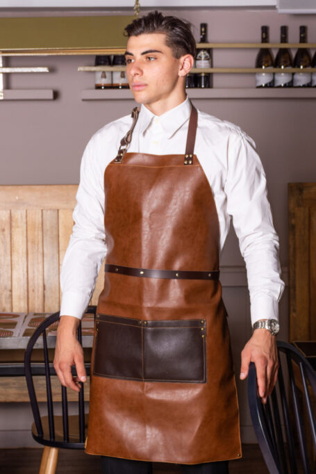 Light brown leather apron with dark brown pockets, adjustable neck strap and belt, special backside lining and more details. Suitable for men and women. Ideal for waiters and baristas. Stylish and comfortable. Easy to wash and maintain.