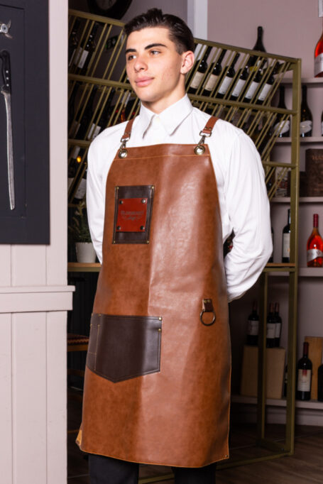 Light brown leather apron with dark brown pocket, adjustable straps, special backside lining and more details. Suitable for men and women. Ideal for waiters and baristas. Stylish and comfortable. Easy to wash and maintain.