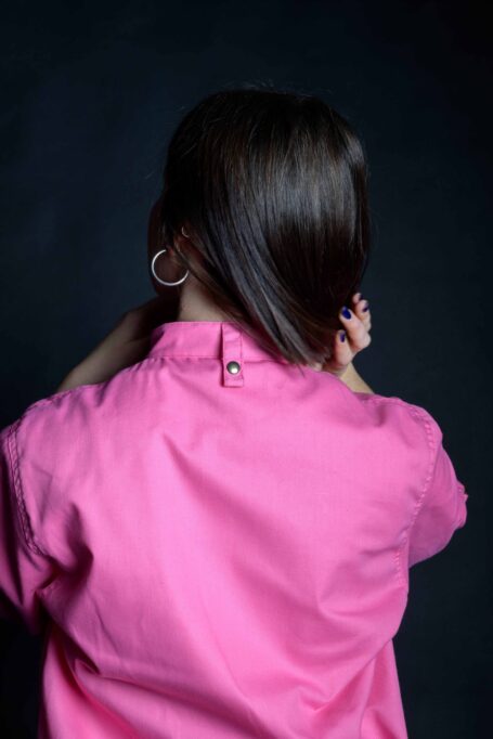 Uniquely designed pink chef jacket with a metal bronze stud button on neck.