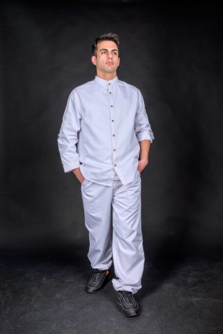 Chef wearing custom chef coat with matching white pants. Stylish workwear that can be worn as street wear clothes as well.
