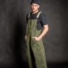Young man wearing his olive green baggy overall, made from high quality cotton fabric, with metal bronze stud buttons and two front pockets