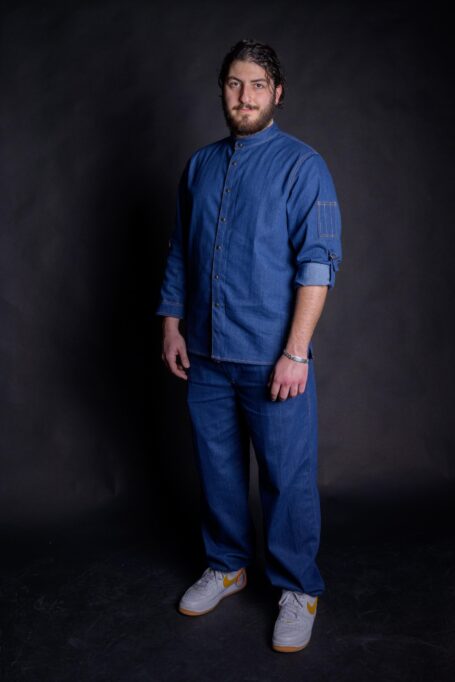 Chef wearing custom chef coat, with matching blue denim pants. Stylish workwear for everyday use in restaurants and kitchen.
