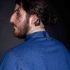 Metal bronze stud button on neck on baker’s custom shirt, because details make the difference.