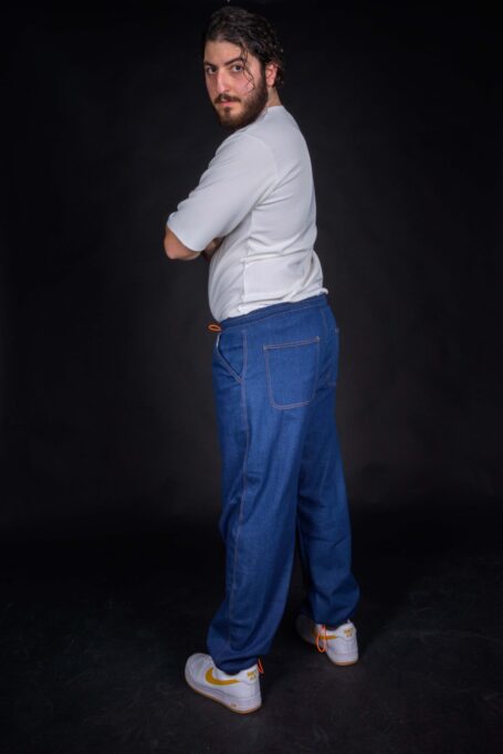 Wood worker wearing durable and breathable blue denim fabric pants with a white t-shirt.