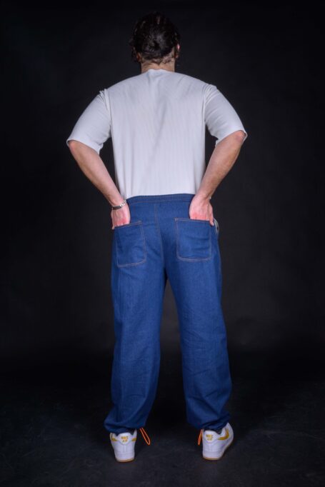 Custom blue denim work pants with two back pockets. Unisex street style pants made from medium weight breathable fabric.