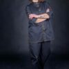 Chef wearing her beautifully designed chef clothes, with external decorative orange thread stitches.