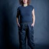 Customizable black pants with two front-side pockets and adjustable elastic ankle cuffs. Craft maker wearing a black t-shirt and her stylish workwear pants which can be worn as street style pants as well.
