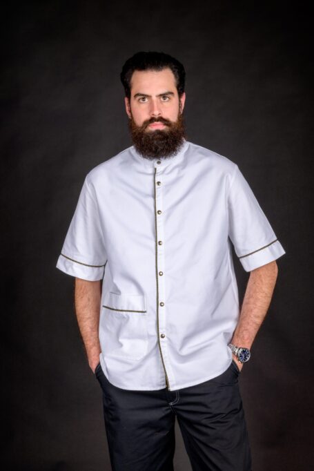 Hair stylist wearing his fashionable workwear jacket smock, made from medium weight durable white fabric.