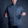 Barber wearing his comfortable loose fit barber shirt in black color.