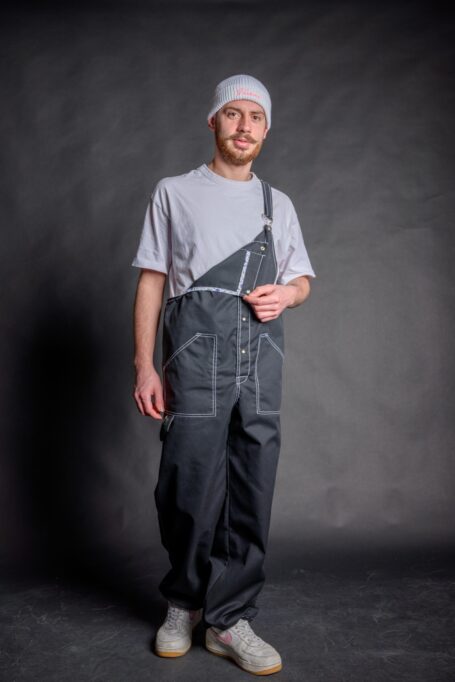 Barista’s comfortable and breathable black fabric dungaree with external decorative white stitches and details.