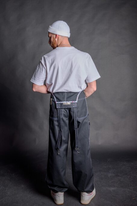 Bartender wearing stylish, breathable and durable black overall pants with his white t-shirt.