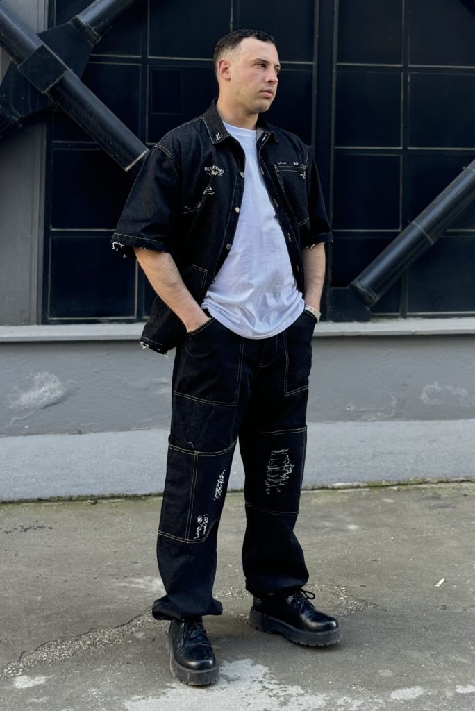 Streetwear gray denim jacket with frayed edges and rips.
